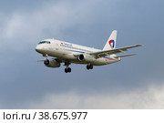 SAINT PETERSBURG, RUSSIA - OCTOBER 28, 2020: Suhoy SuperJet 100-95LR "Mikhail Zhukov" (RA-89117) of Severstal Airlines on glide path in cloudy sky. Редакционное фото, фотограф Виктор Карасев / Фотобанк Лори