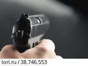 Gun in the man's hand. Point of view. Стоковое фото, фотограф Happyphotons / Фотобанк Лори