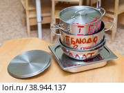 Россия. Санкт-Петербург. Организация питания детей в детском саду. Дети сервируют столы перед приемом пищи. Russia. Saint-Petersburg. Catering for children in kindergarten. Children are served tables before meals. Стоковое фото, фотограф Алексей Смышляев / Фотобанк Лори