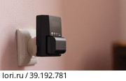 The battery for the camera is charged from an outlet on the wall. Стоковое видео, видеограф Константин Шишкин / Фотобанк Лори