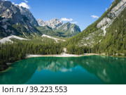 Aerial view on the Pragser Wildsee, a lake in South Tyrolean Dolomites. High mountain chains around the lake. The sky and mountains are reflecting in the lake. Стоковое фото, фотограф Igor Tichonow / Фотобанк Лори
