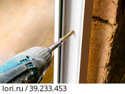 Work with a screwdriver when installing the window. Стоковое фото, фотограф Siarhei Starastau / Фотобанк Лори