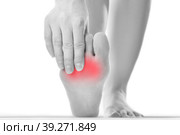 Joint diseases, hallux valgus, plantar fasciitis, heel spur, woman's leg hurts, pain in the foot, massage of female feet isolated on white background. Стоковое фото, фотограф Станислав Тарко / Фотобанк Лори