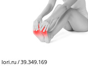 Pain in woman's legs, massage of female feet isolated on white background. Стоковое фото, фотограф Станислав Тарко / Фотобанк Лори
