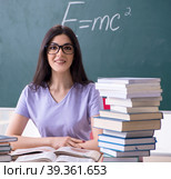 Young female teacher student in front of green board. Стоковое фото, фотограф Elnur / Фотобанк Лори