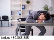 Young male employee in oversleeping concept. Стоковое фото, фотограф Elnur / Фотобанк Лори