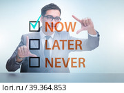 Concept of procrastination with now or later. Стоковое фото, фотограф Elnur / Фотобанк Лори