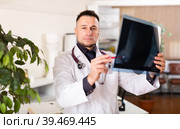 Man doctor analyzing roentgenogram in his office. Стоковое фото, фотограф Яков Филимонов / Фотобанк Лори