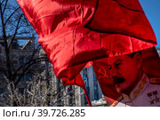 Сторонники партии КПРФ держат флаг СССР и портрет Иосифа Виссарионовича Сталина во время праздничного митинга ко Дню защитника Отечества на площади Революции в центре города Москвы, Россия (2023 год). Редакционное фото, фотограф Николай Винокуров / Фотобанк Лори