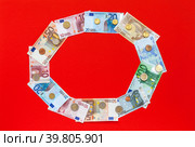 Top view of euro banknotes of different denominations and euro cents coins arranged in  circle on red background. Empty space for text in center. Financial business background. Flat lay, mock up. Стоковое фото, фотограф Виктория Катьянова / Фотобанк Лори