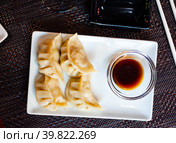 Japanese tasty dumplings gyozas with soy sauce. Стоковое фото, фотограф Яков Филимонов / Фотобанк Лори