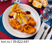 Crisp chicken nuggets with golden brown crust and french fries. Стоковое фото, фотограф Яков Филимонов / Фотобанк Лори