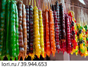 Multicolored delicious fresh Georgian Sweets snack. Churchkhela hanging in the market. (2016 год). Стоковое фото, фотограф Elena Titova / Фотобанк Лори