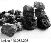 Dark colorless stones of various shapes and sizes in a small pile, close-up on white. Sketch with black and gray rubble; simplified contrast illustration, ink imitation, fine oblique hatching. Стоковая иллюстрация, иллюстратор Анатолий Власов / Фотобанк Лори
