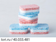 Dishwasher tablets on a white background. The use of powder for washing dishes. Стоковое фото, фотограф Александр Поташев / Фотобанк Лори