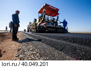 Kyzylorda province, Kazakhstan, April 29, 2012: Construction of West Europe-West China new highway. Dynapac road machine and asphalt layers. Стоковое фото, фотограф Alexey Rezvykh / Фотобанк Лори