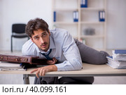 Young male employee in oversleeping concept. Стоковое фото, фотограф Elnur / Фотобанк Лори