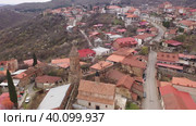 Aerial view of residential areas of small mountainous town of Sighnaghi on hillside in springtime, Kakheti region, Georgia. Стоковое видео, видеограф Яков Филимонов / Фотобанк Лори