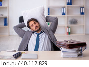 Young male employee in oversleeping concept. Стоковое фото, фотограф Elnur / Фотобанк Лори