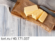 Cut butter on plate with blue towel on kitchen table. Стоковое фото, фотограф Сергей Толмачёв / Фотобанк Лори