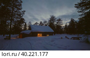 Западная Сибирь, стойбище оленеводов ханты: изба в лесу вечером. Western Siberia, Khanty people's camp: a hut in the forest in the evening. Стоковое видео, видеограф Евгений Романов / Фотобанк Лори