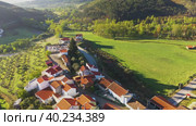 Aerial view of small rural town with red roofs during sunrise time (2019 год). Стоковое видео, видеограф Кирилл Трифонов / Фотобанк Лори