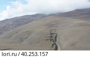 Drone flying above gorge toward terraced mountain slope. Стоковое видео, видеограф Кирилл Трифонов / Фотобанк Лори