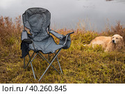 Tourist collapsible chair on the background of the autumn landscape. Стоковое фото, фотограф Александр Поташев / Фотобанк Лори