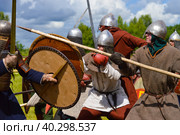 Pskov, Russia, July 10. 2022. Epic Invading Army of Medieval Knights on Battlefield, Plate Body Armored Soldiers with Swords in Battle Cry. Historical Reenactment. Редакционное фото, фотограф Ирина Старикова / Фотобанк Лори