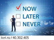 Concept of procrastination with now or later. Стоковое фото, фотограф Elnur / Фотобанк Лори