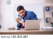 Young male employee in remuneration concept. Стоковое фото, фотограф Elnur / Фотобанк Лори