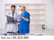 Two male doctors radiologists working in the clinic. Стоковое фото, фотограф Elnur / Фотобанк Лори