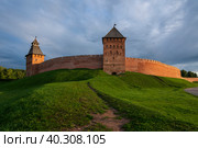 View of the wall of the Novgorod Kremlin, the Dvortsovaya and Spasskaya Towers on an early cloudy summer morning, Veliky Novgorod, Novgorod region, Russia. Стоковое фото, фотограф Ula Ulachka / Фотобанк Лори