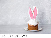 Easter cake with rabbit (hare) ears on a light concrete background. Happy Easter. Стоковое фото, фотограф Photojuli / Фотобанк Лори