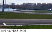 A sports car goes through a turn in a slide. Drift competitions at the Moscow stadium technical sports. (2023 год). Редакционное видео, видеограф Ярославский Максим / Фотобанк Лори