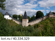 View of the wall of the Holy Dormition Pskov-Pechersk Monastery, the Tower of the Upper Lattices, Tailovskaya tower and Tararygin Tower on a sunny summer day, Pechory, Pskov region, Russia. Стоковое фото, фотограф Ula Ulachka / Фотобанк Лори