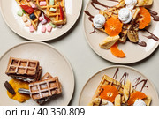 Sweet Belgian waffles with fruits, berries, cream and marshmallows. Top view on a light background, hard light, top view. Стоковое фото, фотограф Bogdanova Mariia / Фотобанк Лори
