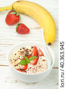 Traditional healthy Breakfast. Natural yogurt with strawberries, banana and chocolate. Selective focus. Стоковое фото, фотограф Виктория Панченко / Фотобанк Лори