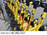 Krasnogorsk, Russia - July 12. 2022 Short-term rental service for electric scooters Yandex Go. Редакционное фото, фотограф Володина Ольга / Фотобанк Лори
