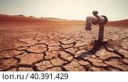 A faucet from which a drop of water drips onto the soil cracked by drought. The concept of abnormal heat and drought on the planet earth. AI generated. Стоковое AI-изображение, AI-художник ALLA YURTAYEVA / Фотобанк Лори