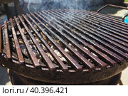 Grill - a portable installation for cooking on coals, in the heat. Direct method of cooking meat. The remaining fat burns and forms acrid carcinogenic smoke with aromatic hydrocarbons. Smoking grill. Стоковое фото, фотограф Юлия Петровская / Фотобанк Лори