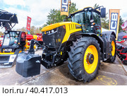 Modern agricultural wheeled tractor JCB exhibited at the annual Volga agro-industrial exhibition (2019 год). Редакционное фото, фотограф FotograFF / Фотобанк Лори