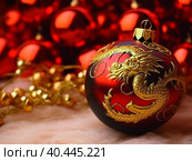 Christmas tree ball with the image of a golden Chinese dragon. Created by AI. Стоковое AI-изображение, AI-художник Ярославский Максим / Фотобанк Лори