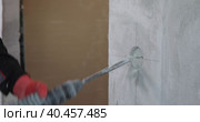 An electrician drills holes in the wall for sockets using a power tool. Close-up. Стоковое видео, видеограф Юрий Поздников / Фотобанк Лори