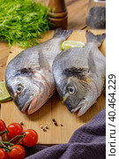 Raw peeled dorado fish with cooking ingredients. Fresh fish on a wooden background. Стоковое фото, фотограф Юрий Поздников / Фотобанк Лори