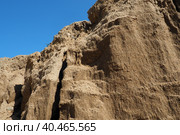 Sandstone is a fragmentary sedimentary rock, a homogeneous or layered aggregate of fragmentary grains and grains of sand bound by any mineral substance, cement. Quarry natural yellow sand wall. Стоковое фото, фотограф Юлия Петровская / Фотобанк Лори