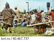 Russia, Staraya Ladoga 23,06,2012 Reenactors with shields and spears during the battle, the festival of historical reconstruction "Pages of History" Стоковое фото, фотограф Анна Кривицкая / Фотобанк Лори