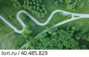 Curvy bike path. Laid between the trees in the park. Drone photography, aerial photography. The camera is tilted vertically down. Стоковое видео, видеограф Vadzim Yakubovich / Фотобанк Лори