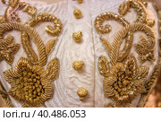 Vintage gold embroidery on an old white dress with gold buttons. Стоковое фото, фотограф Iva Noel / Фотобанк Лори
