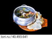 Sautéed seafood in pot close up isolated on black background side view. Стоковое фото, фотограф Татьяна Терехина / Фотобанк Лори